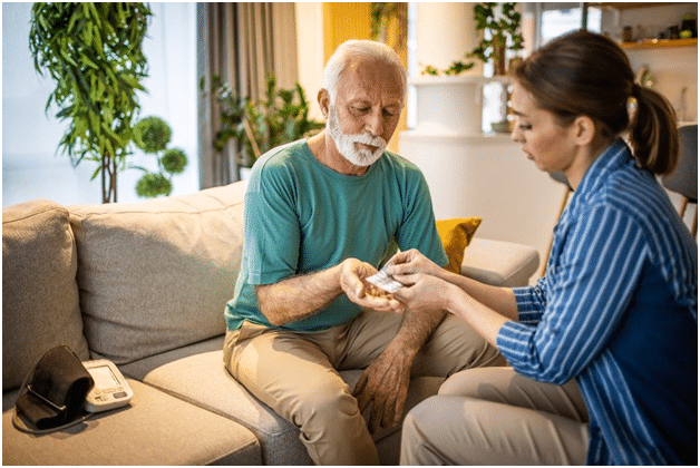 An older man gives his old hearing aids to his wife to donate them to someone in need.